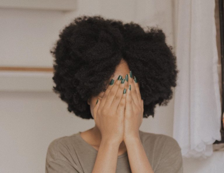 woman hiding her face with her hands